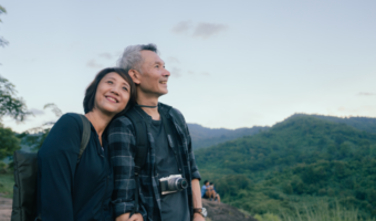 Older couple smiling and enjoying a beautiful view.