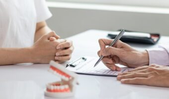 Dentist and patient going through benefit documents.
