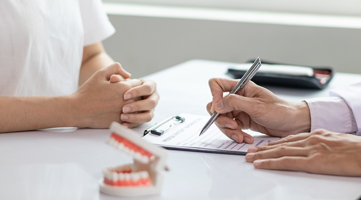 Dentist and patient going through benefit documents.