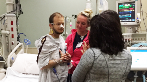 Nate stands just hours after receiving a new heart transplant from a registered organ donor.