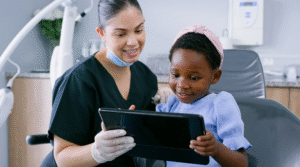 Dental Assistant talking to child.
