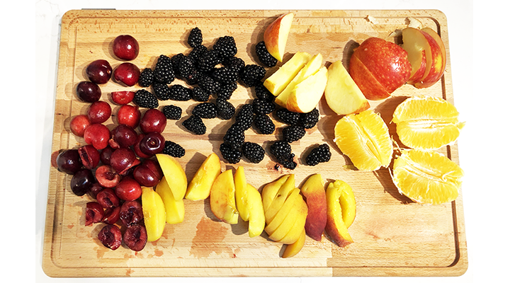 Fruit for low-sugar sangria including cherries, blackberries, apples, oranges, and peaches