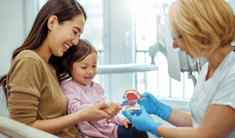 Mother and daughter getting comfortable with the dentist.