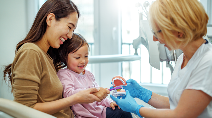 Mother and daughter getting comfortable with the dentist.