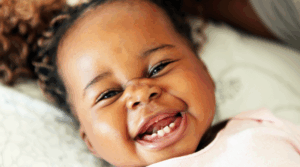 Baby laughing and smiling.
