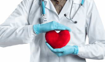 Doctor holding a heart pillow.