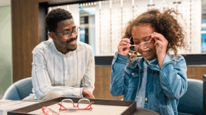 Kid getting fitted for glasses at the eye doctor.