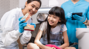 Child learning about oral health from a dentist.
