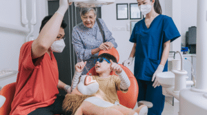 Dentist helping a child feel more comfortable in the dental chair.