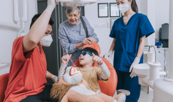 Dentist helping a child feel more comfortable in the dental chair.
