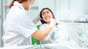 Girl smiling and sitting in dentist chair.