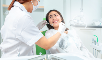 Girl smiling and sitting in dentist chair.