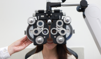 Person smiling and getting a vision check-up.