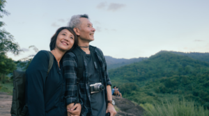 Older couple smiling and enjoying a beautiful view.