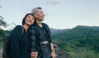 Older couple smiling and enjoying a beautiful view.