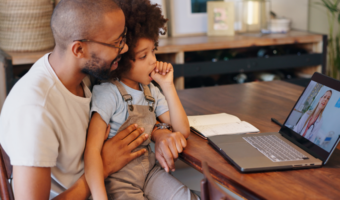 Parent and child talking to dentist on their computer.