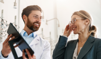 Eye doctor providing glasses to a patient.