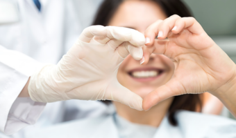 Person making a heart with their hands.