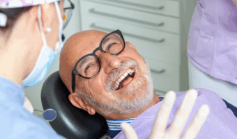 Person smiling in the dental chair.