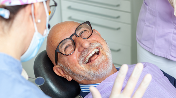 Person smiling in the dental chair.
