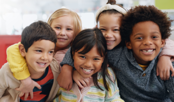 Group of children smiling together.