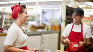 Two people working and smiling at their small business.