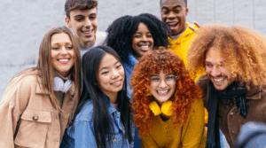 Group of young adults smiling together.