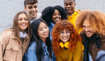 Group of young adults smiling together.