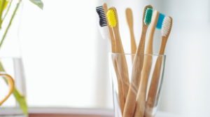 Group of bamboo toothbrushes in a cup.