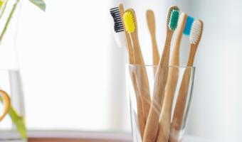 Group of bamboo toothbrushes in a cup.