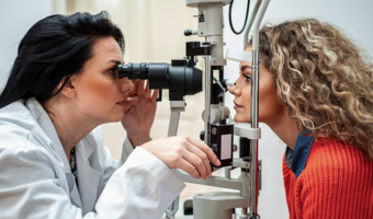 Woman getting an eye exam from an eye doctor.