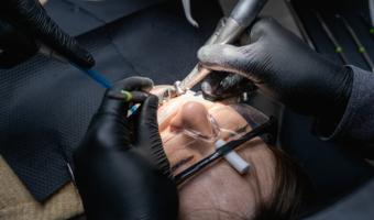 Person getting their tooth reshaped in the dental chair.
