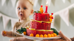 Child looking at a delicious watermelon cake.
