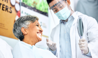 Dentist giving an exam to an older adult.